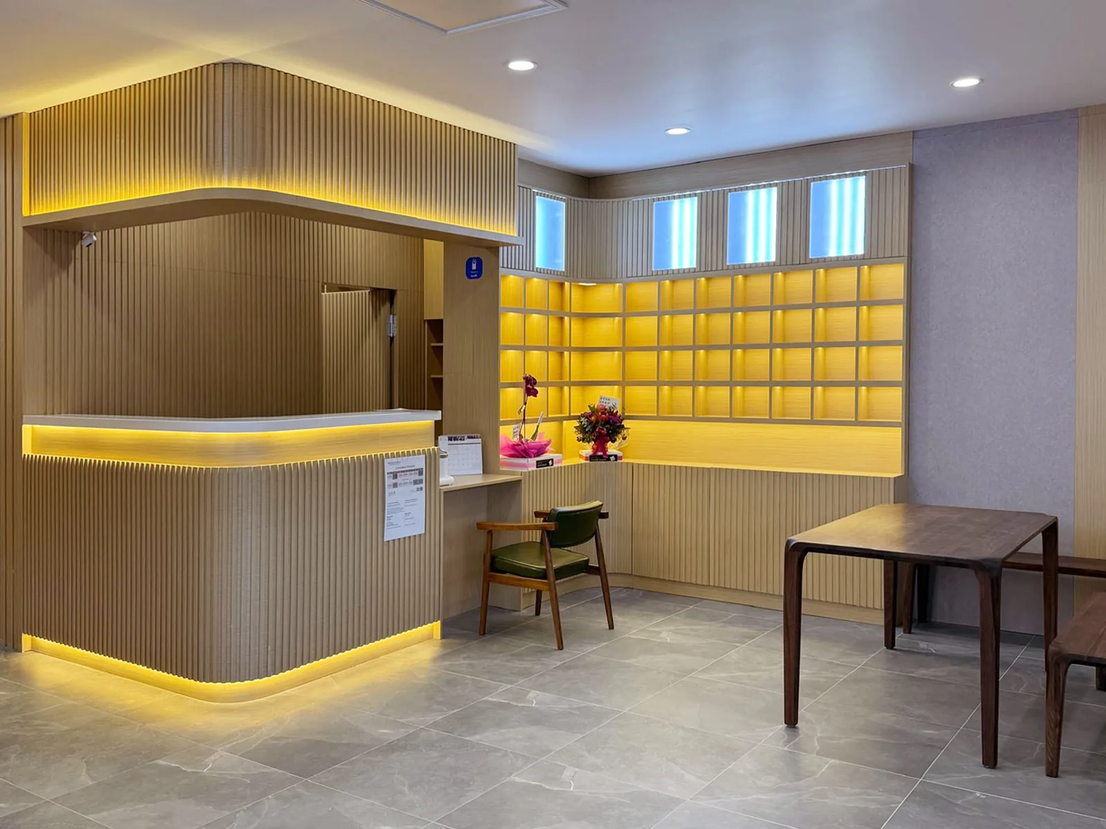 Reception desk with white counter and amber dispensary wall behind