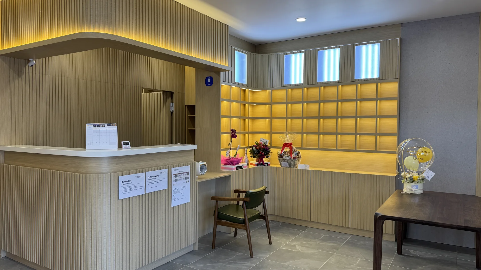 Prime & Naturals reception — glowing amber herbal-dispensary wall of cubby-shelf jars
