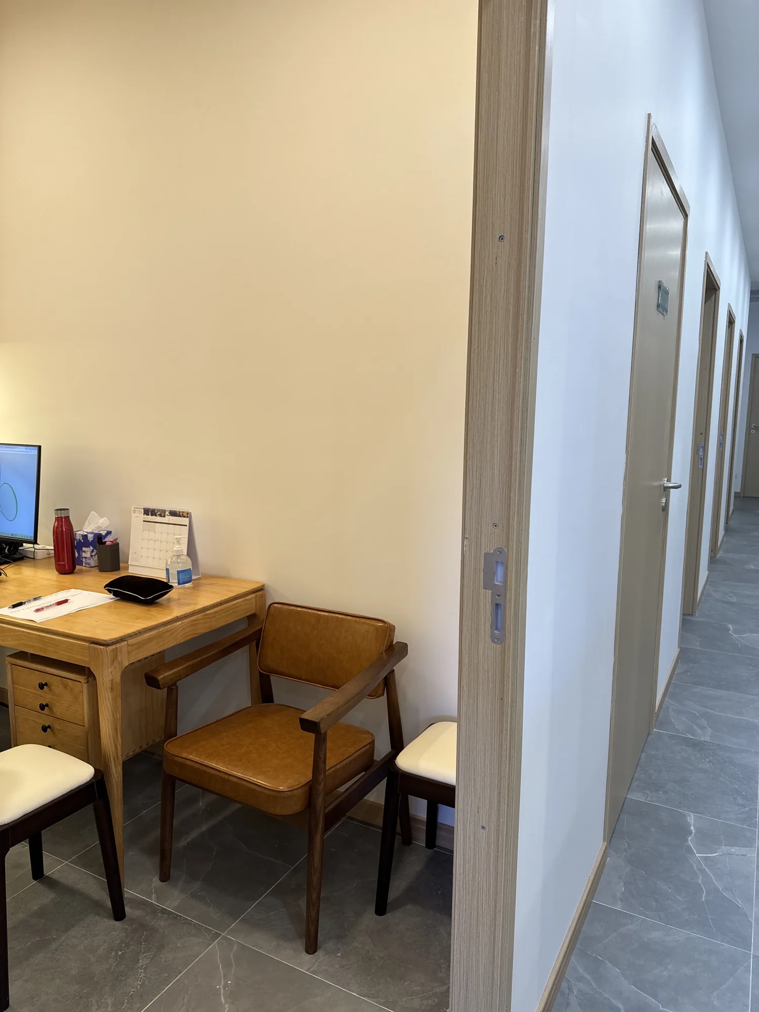 Consultation desk beside the corridor of private treatment rooms at Prime & Naturals